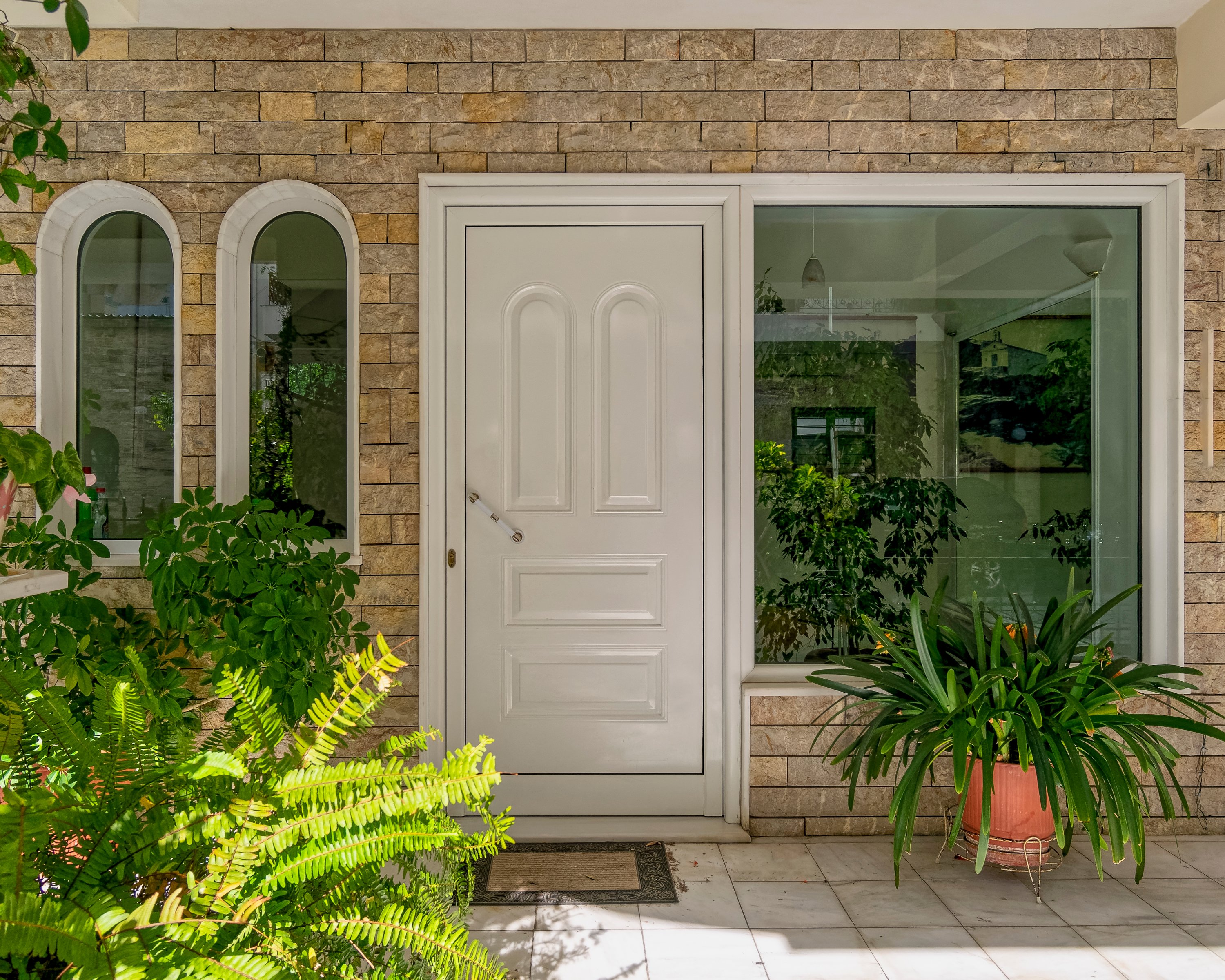 Why do the entry doors to most homes open inward, while in most