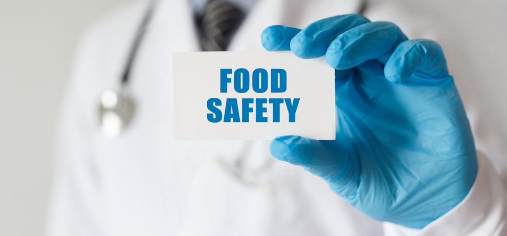 Inspector holding a food safety card
